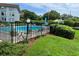 Community swimming pool with surrounding lawn at 333 Lake Howard Nw Dr # 202C, Winter Haven, FL 33880