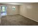 Spacious dining area with neutral carpeting and a chandelier at 333 Lake Howard Nw Dr # 202C, Winter Haven, FL 33880