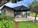 Community patio with seating, a bar, and grill at 333 Lake Howard Nw Dr # 202C, Winter Haven, FL 33880