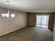 Bright living room featuring neutral carpeting and a chandelier at 333 Lake Howard Nw Dr # 202C, Winter Haven, FL 33880