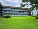 Apartment building with lush landscaping and a large lawn at 333 Lake Howard Nw Dr # 202C, Winter Haven, FL 33880