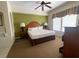 King-size bed, ceiling fan, and large windows in this main bedroom at 8101 Resort Village Dr # 3303, Orlando, FL 32821