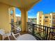 Balcony with table and chairs, offering scenic views of the resort at 8101 Resort Village Dr # 3303, Orlando, FL 32821