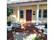 Inviting front entrance with a red door and brick steps leading to the porch at 495 S Orange Ave, Bartow, FL 33830