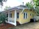 Charming yellow house with a front porch and well-maintained landscaping at 495 S Orange Ave, Bartow, FL 33830