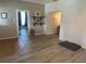 Open concept living area with wood-look flooring and access to other rooms at 815 E Church St, Bartow, FL 33830