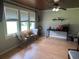 Bright living room with wood floors, large windows, and ceiling fan at 815 E Church St, Bartow, FL 33830
