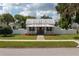 Charming craftsman home with a metal roof, red door, and landscaped yard at 815 E Church St, Bartow, FL 33830
