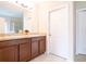 Double vanity bathroom with a large mirror and brown cabinets at 4814 Rockvale Dr, Kissimmee, FL 34758