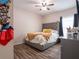 Bedroom with a queen bed and gray upholstered headboard at 4814 Rockvale Dr, Kissimmee, FL 34758