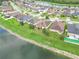 Aerial view of neighborhood with lake and houses at 4814 Rockvale Dr, Kissimmee, FL 34758