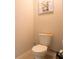 Small powder room with toilet and wall art at 4814 Rockvale Dr, Kissimmee, FL 34758