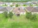 Backyard view of house with screened porch and solar panels at 4814 Rockvale Dr, Kissimmee, FL 34758