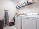 Laundry room with washer, dryer, and shelving at 4814 Rockvale Dr, Kissimmee, FL 34758