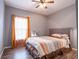 Bedroom with a queen bed and orange and brown bedding at 4814 Rockvale Dr, Kissimmee, FL 34758