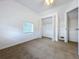 Bright bedroom with carpeted floor, window, and spacious closet at 1010 Martin Luther King Jr Blvd, Bartow, FL 33830