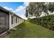 Landscaped backyard with a large green lawn and hedges at 2178 Sunstone Dr, Lakeland, FL 33813