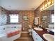 Bathroom with double sinks, a bathtub, and updated flooring at 2178 Sunstone Dr, Lakeland, FL 33813
