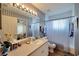 Bathroom with shower/tub combo, toilet, and vanity with a large mirror at 2178 Sunstone Dr, Lakeland, FL 33813