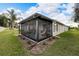 Home exterior showcasing a screened porch and well-manicured lawn at 2178 Sunstone Dr, Lakeland, FL 33813