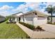 Front view of a house with walkway and nicely landscaped yard at 2178 Sunstone Dr, Lakeland, FL 33813