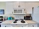 White appliances, including a microwave and stovetop, are in this kitchen at 2178 Sunstone Dr, Lakeland, FL 33813