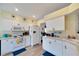 Bright kitchen with white cabinets, modern appliances, and light wood flooring at 2178 Sunstone Dr, Lakeland, FL 33813