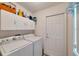 Laundry room with washer, dryer, cabinets, and exterior access at 2178 Sunstone Dr, Lakeland, FL 33813