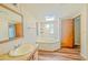 Bathroom with corner tub, vanity, and skylight at 408 Garrett Ridge Ct, Winter Haven, FL 33880
