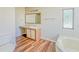 Bathroom with corner tub, vanity, and wood-look floors at 408 Garrett Ridge Ct, Winter Haven, FL 33880