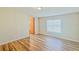 Simple bedroom with wood-look floors and a window with blinds at 408 Garrett Ridge Ct, Winter Haven, FL 33880