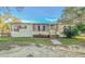 Mobile home exterior features a screened porch and well-maintained lawn at 408 Garrett Ridge Ct, Winter Haven, FL 33880