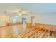 Open living room with wood-look floors and access to kitchen at 408 Garrett Ridge Ct, Winter Haven, FL 33880