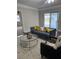 Living room with sliding glass doors, a gray sofa, and wood floors at 503 Se 3Rd St, Mulberry, FL 33860