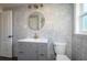 Modern bathroom with gray tile, gray vanity, and gold fixtures at 505 N Polk Ave, Fort Meade, FL 33841