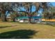 Newly renovated home with green metal roof and large yard at 505 N Polk Ave, Fort Meade, FL 33841