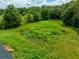 Aerial view of a vacant lot with overgrown vegetation and a small pond at 10109 Old Spanish Trl, Polk City, FL 33868