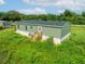 Green mobile home with a wooden deck and steps, set in a grassy area at 10109 Old Spanish Trl, Polk City, FL 33868