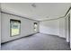 Spacious bedroom with grey carpet and two windows at 10109 Old Spanish Trl, Polk City, FL 33868