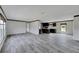 Open concept living room and kitchen with gray plank flooring at 10109 Old Spanish Trl, Polk City, FL 33868
