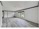 Spacious living room with gray vinyl plank flooring and lots of natural light at 10109 Old Spanish Trl, Polk City, FL 33868