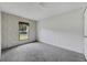 Bright bedroom with a window and grey carpeting at 10109 Old Spanish Trl, Polk City, FL 33868