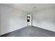 Bedroom with gray carpet and a view into the kitchen at 10109 Old Spanish Trl, Polk City, FL 33868
