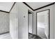 Hallway with doors to bedrooms and carpet flooring at 10109 Old Spanish Trl, Polk City, FL 33868