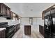 Modern kitchen with dark wood cabinets, stainless steel appliances, and an island at 10109 Old Spanish Trl, Polk City, FL 33868