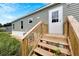 Wooden steps leading to the entrance of a green mobile home at 10109 Old Spanish Trl, Polk City, FL 33868