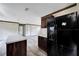 Black refrigerator with water dispenser in modern kitchen at 10109 Old Spanish Trl, Polk City, FL 33868
