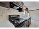 Black stove and dark wood cabinets in a modern kitchen at 10109 Old Spanish Trl, Polk City, FL 33868