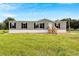 House exterior with green siding and black shutters at 10109 Old Spanish Trl, Polk City, FL 33868
