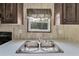 Double stainless steel sink with window overlooking backyard at 10109 Old Spanish Trl, Polk City, FL 33868